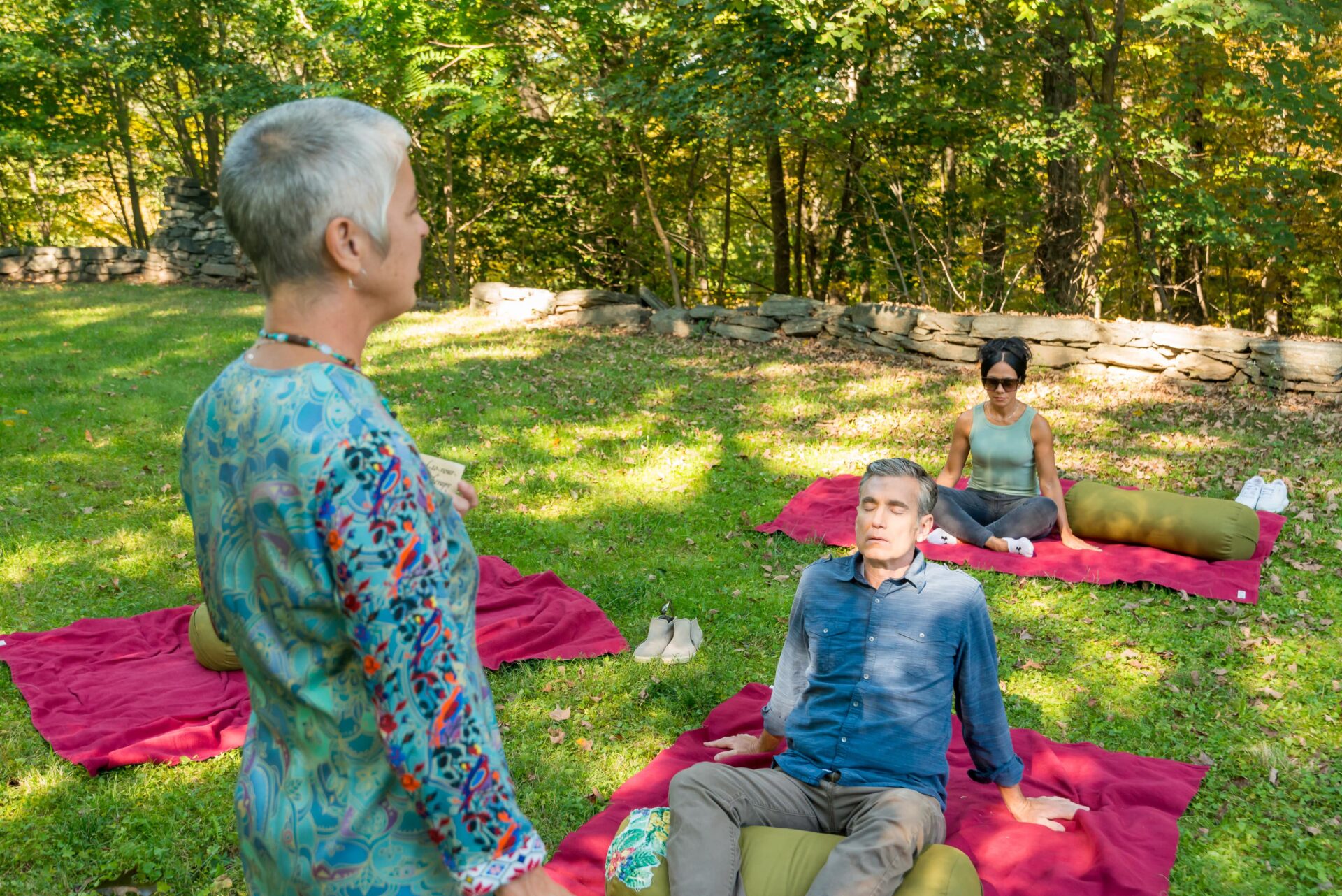 Individuals practicing meditation outside at the Ridge Recovery Center.