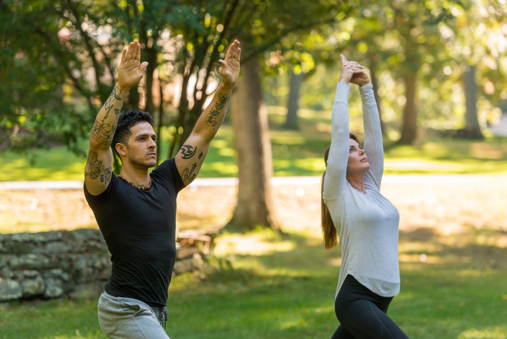 Two individuals practicing yoga outside at the Ridge Recovery Center.