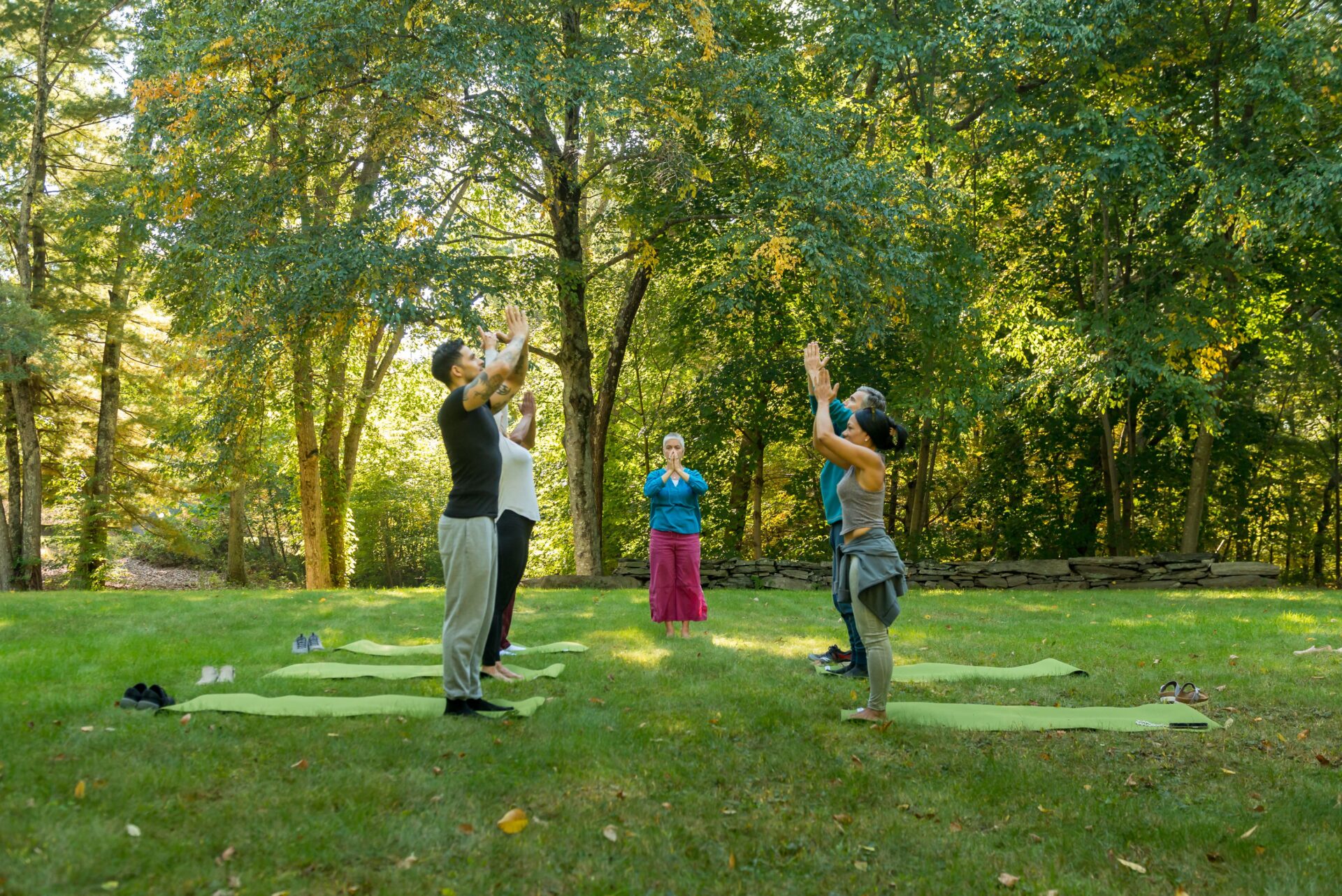 People practicing guided yoga outside at the Ridge Recovery Center in Windham, CT.